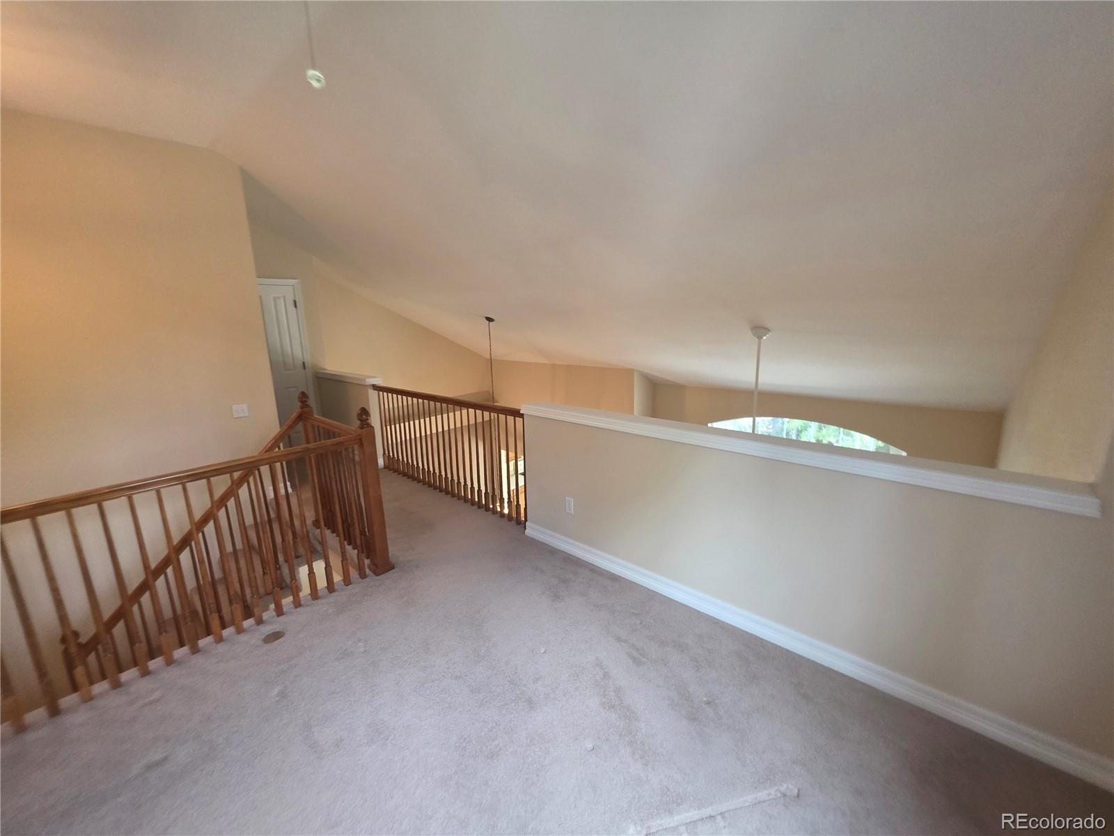 8911 Tappy Toorie Place Highlands Ranch, CO 80129 - Photo 22 of 28 a view of a hallway with an empty room