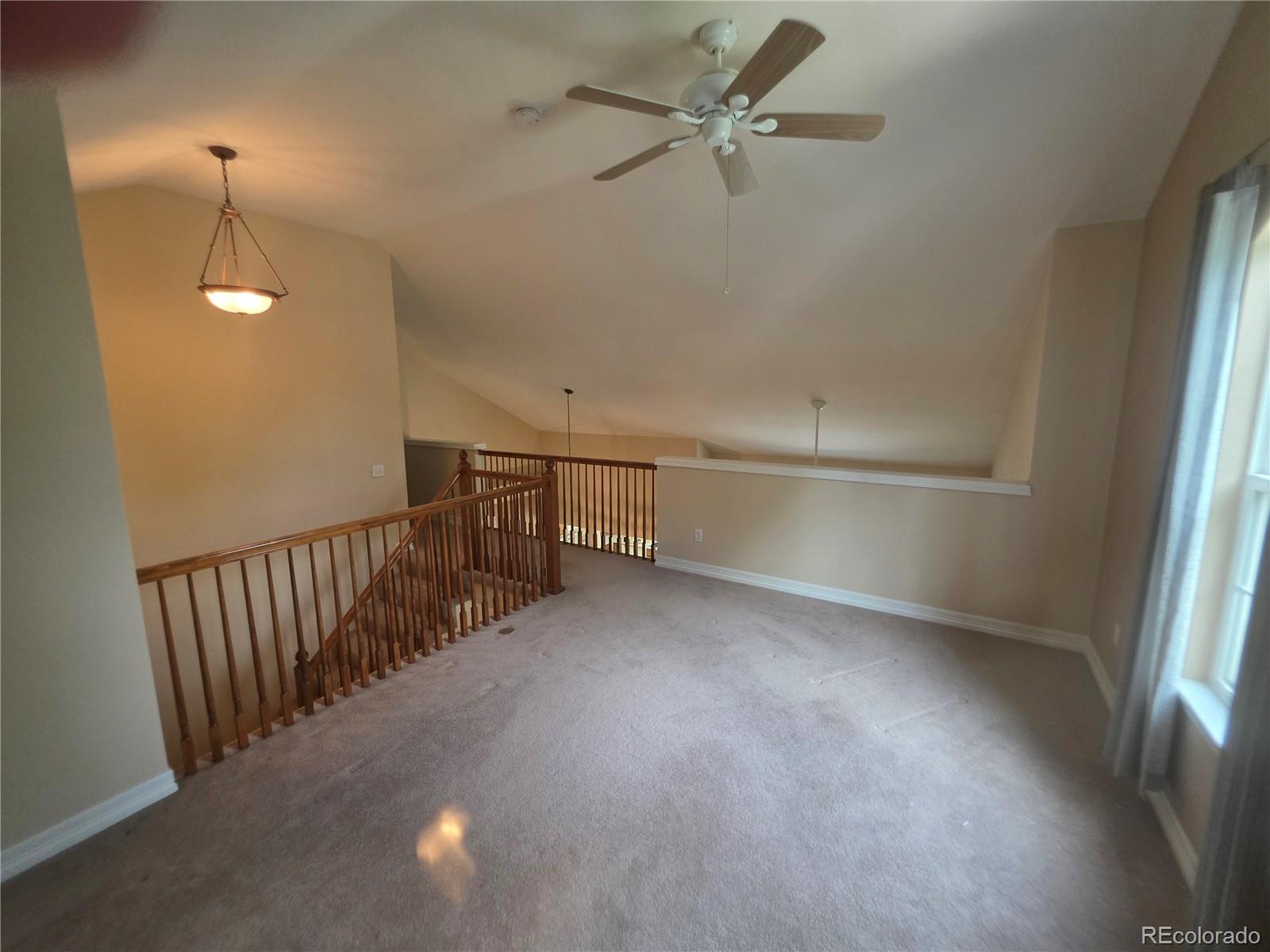 8911 Tappy Toorie Place Highlands Ranch, CO 80129 - Photo 23 of 28 a view of a livingroom with a ceiling fan and window