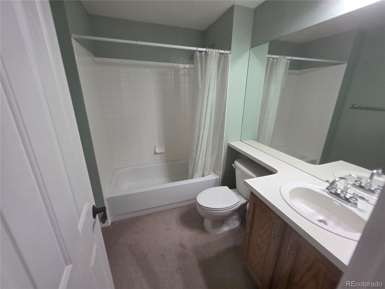 8911 Tappy Toorie Place Highlands Ranch, CO 80129 - Photo 26 of 28 a bathroom with a sink and a mirror