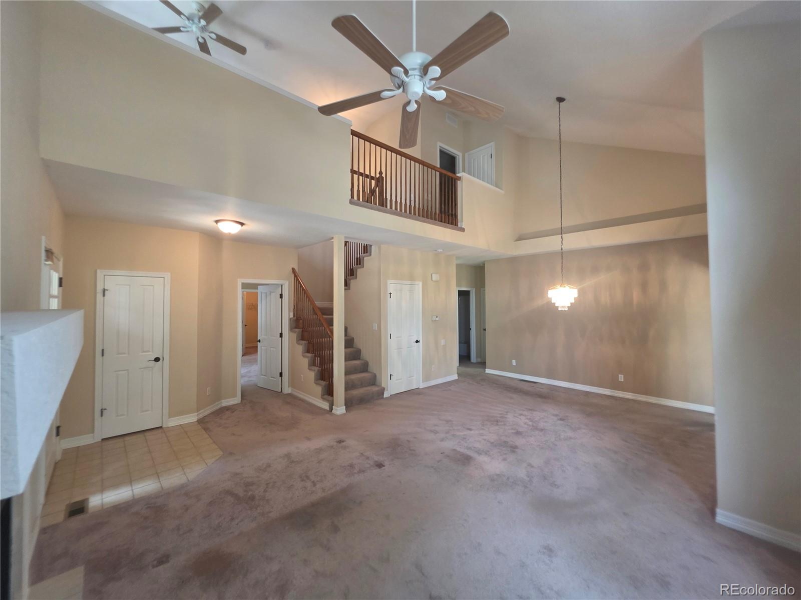 8911 Tappy Toorie Place Highlands Ranch, CO 80129 - Photo 3 of 28 a view of a livingroom with a ceiling fan