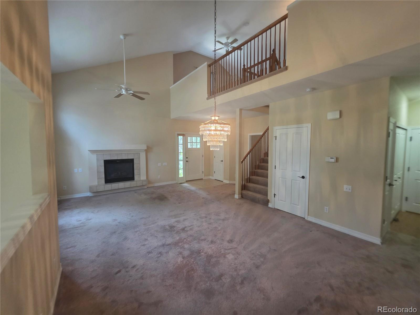 8911 Tappy Toorie Place Highlands Ranch, CO 80129 - Photo 4 of 28 a view of an empty room with a fireplace