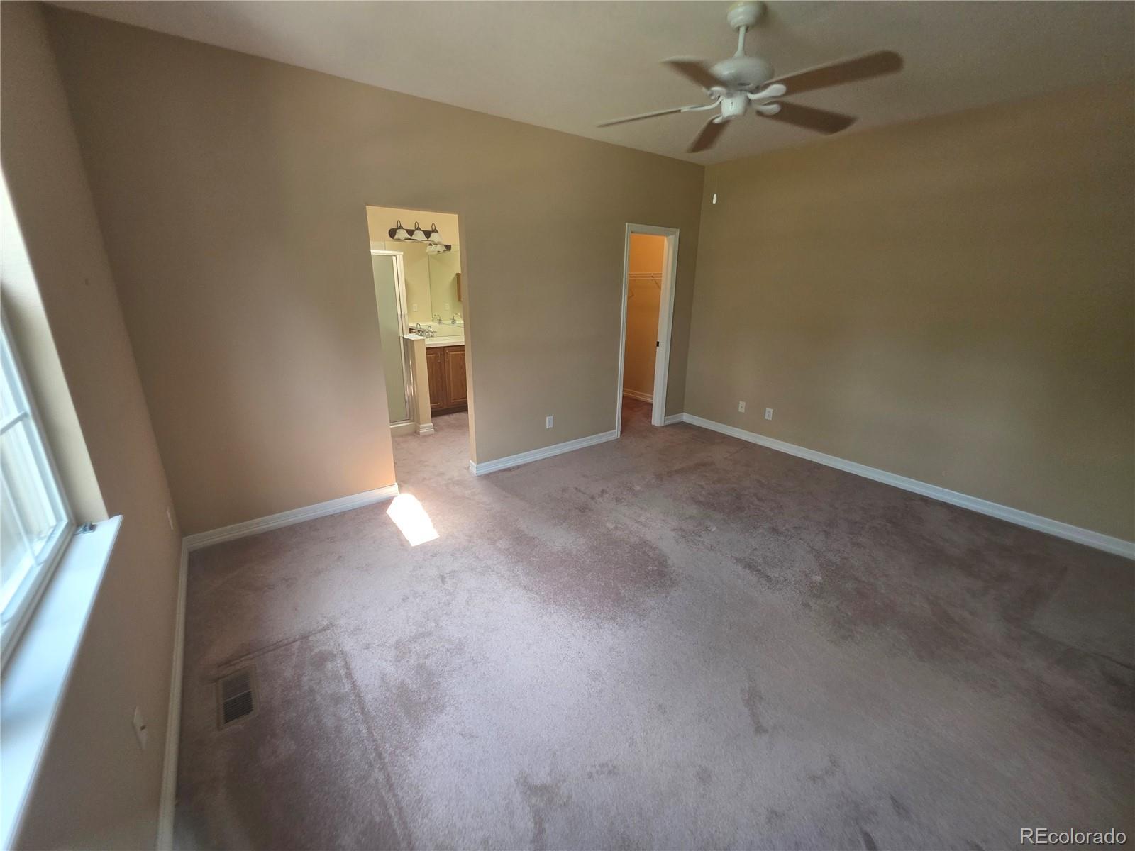 8911 Tappy Toorie Place Highlands Ranch, CO 80129 - Photo 6 of 28 an empty room with windows and fan