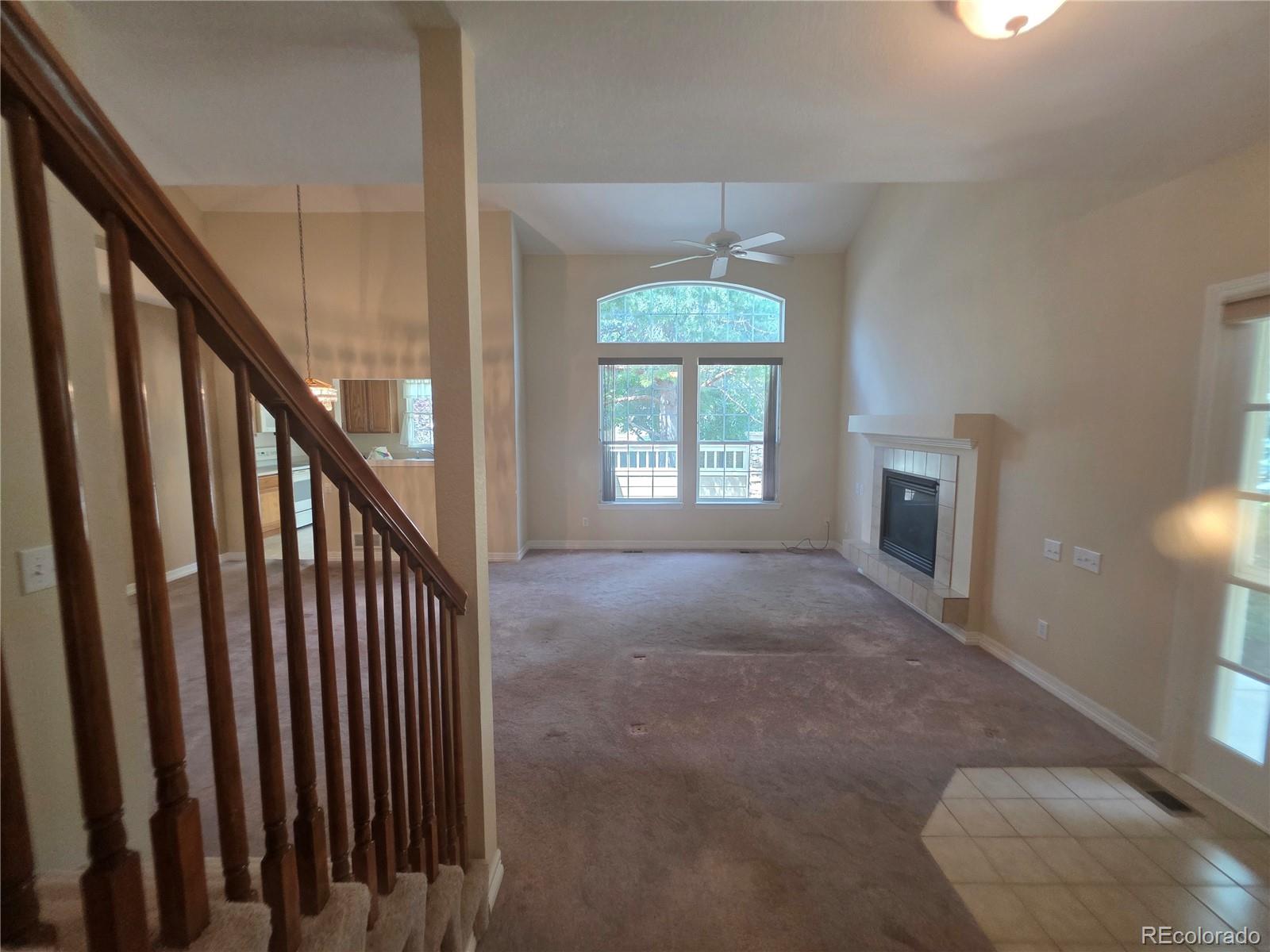 8911 Tappy Toorie Place Highlands Ranch, CO 80129 - Photo 10 of 28 a view of an empty room with wooden floor and fan