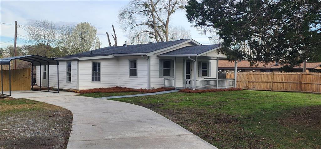 1786 Lake Lucerne Road Southwest Lilburn, GA 30047 - Photo 1 of 1 a view of a yard in front of a house with large tree