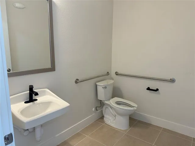 a white toilet sitting next to a bathroom sink