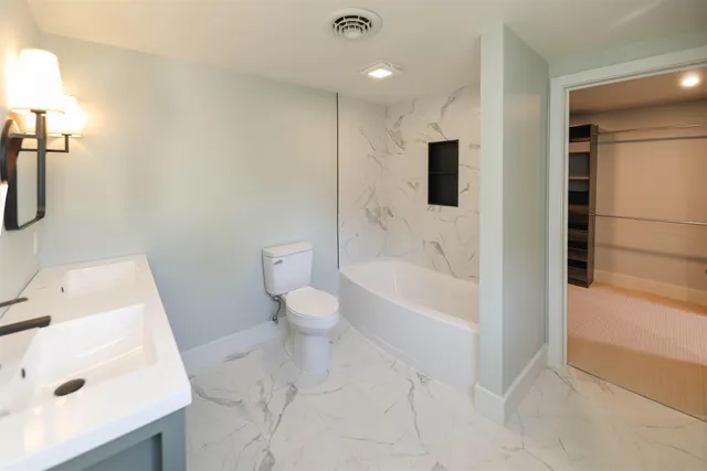 a bathroom with a bathtub sink and toilet