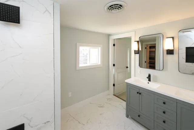a bathroom with a sink and a mirror