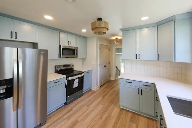 a kitchen with a refrigerator and a sink