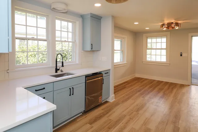 a kitchen with wooden floors and sink