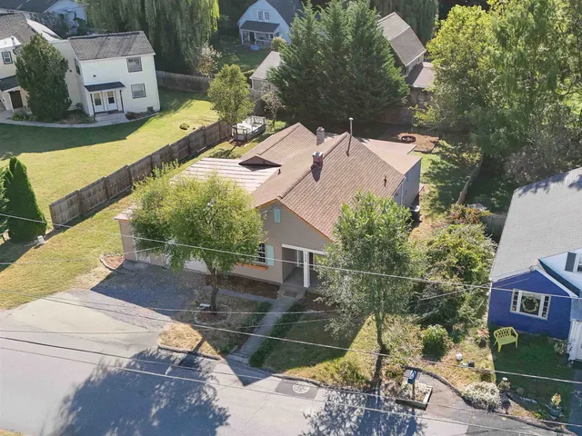 an aerial view of a house with a yard basket ball court and outdoor seating