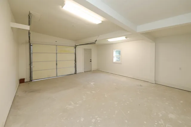 an empty room with a empty space and windows