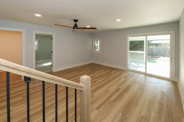 wooden floor in an empty room with a window