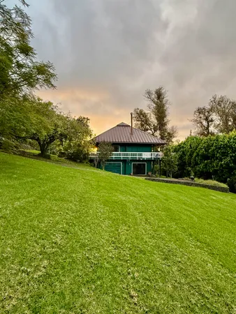 a front view of house with yard barbeque and outdoor seating