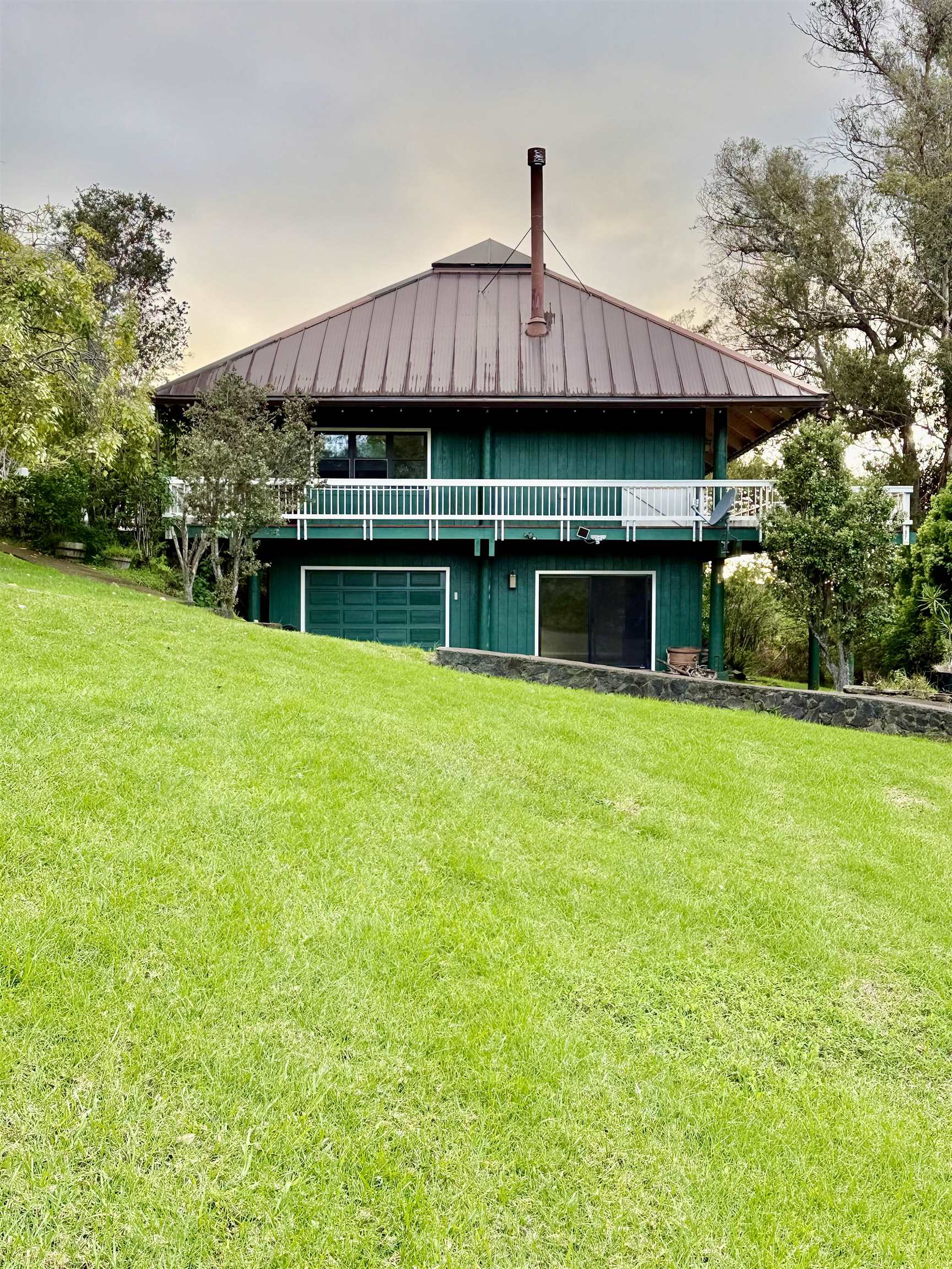 2400 Piiholo Road Makawao, HI 96768 - Photo 3 of 45 a front view of house with yard barbeque and outdoor seating