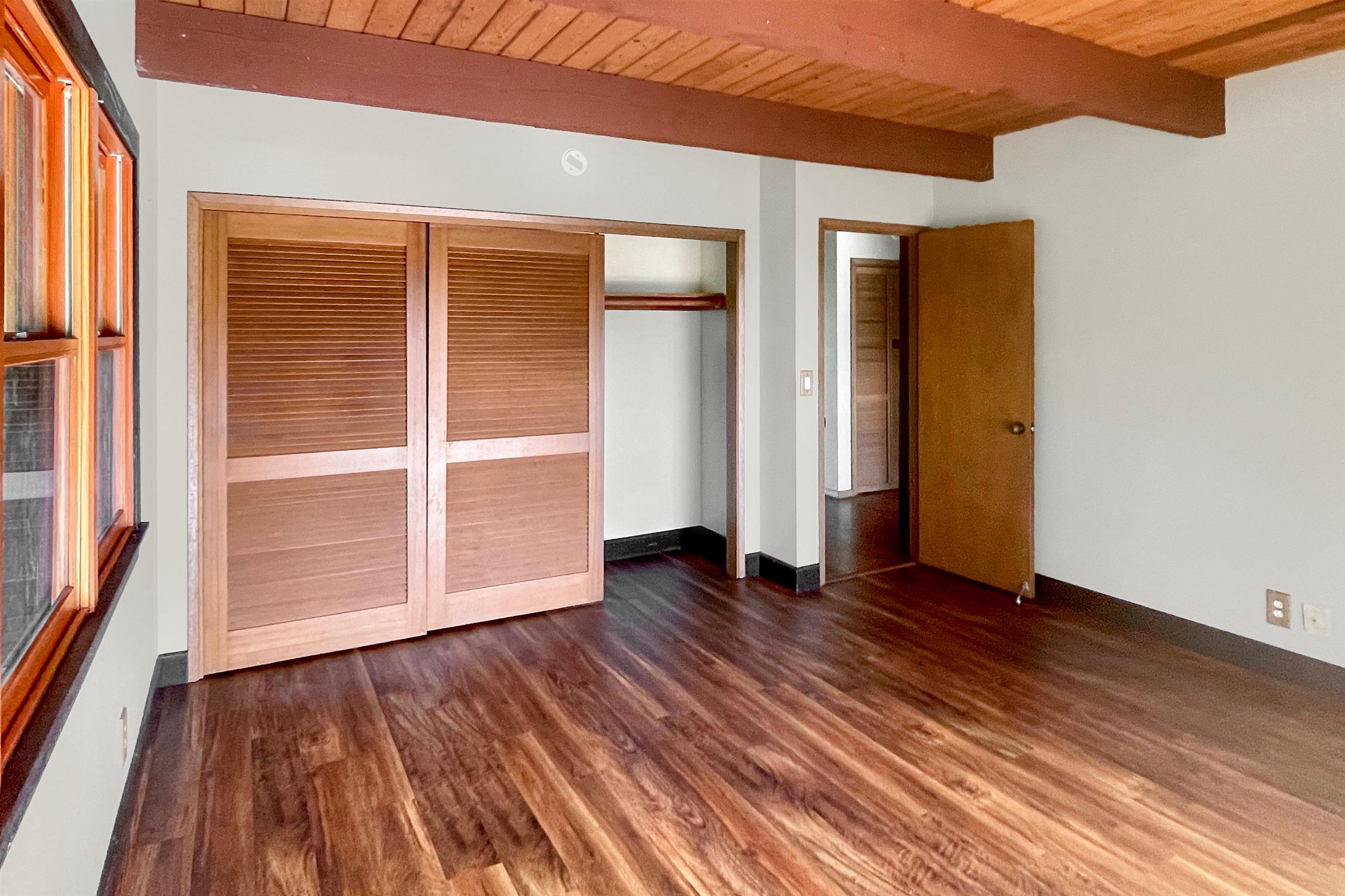 2400 Piiholo Road Makawao, HI 96768 - Photo 32 of 45 a view of an empty room with wooden floor and a window
