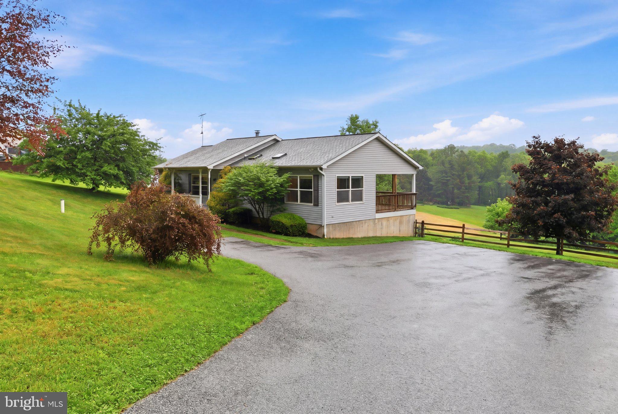 491 Garvine Mill Road Fawn Grove, PA 17321 - Photo 4 of 47 a front view of a house with a garden and yard