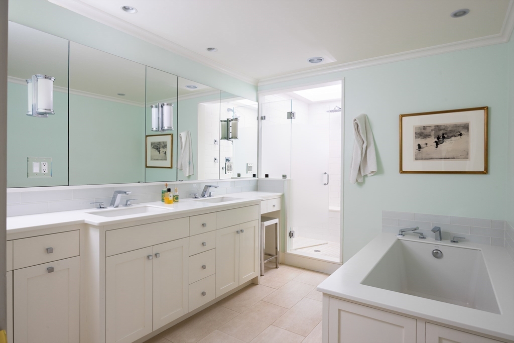 291 Goddard Avenue, Unit 291 Brookline, MA 02445 - Photo 11 of 19 a spacious bathroom with a double vanity sink mirror and bathtub