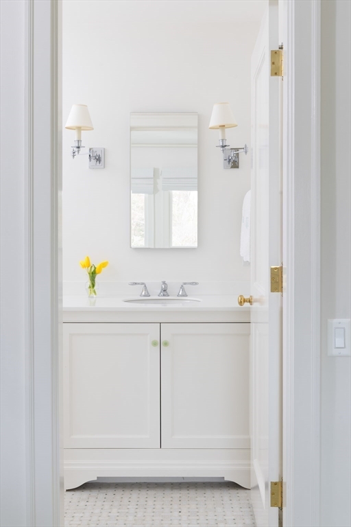 291 Goddard Avenue, Unit 291 Brookline, MA 02445 - Photo 17 of 19 a bathroom with a sink vanity and a mirror