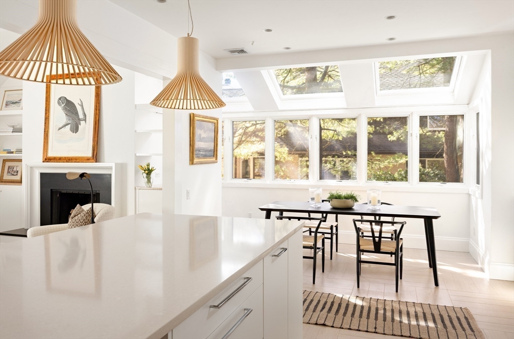 291 Goddard Avenue, Unit 291 Brookline, MA 02445 - Photo 5 of 19 a view of a dining room with furniture window and wooden floor