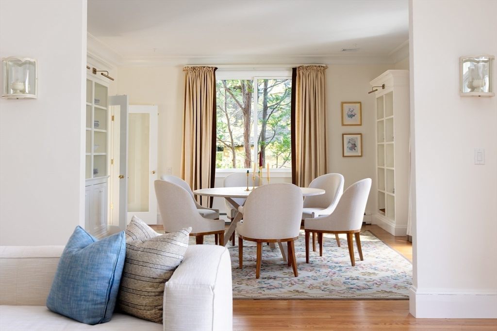 291 Goddard Avenue, Unit 291 Brookline, MA 02445 - Photo 9 of 19 a dining room with furniture and wooden floor