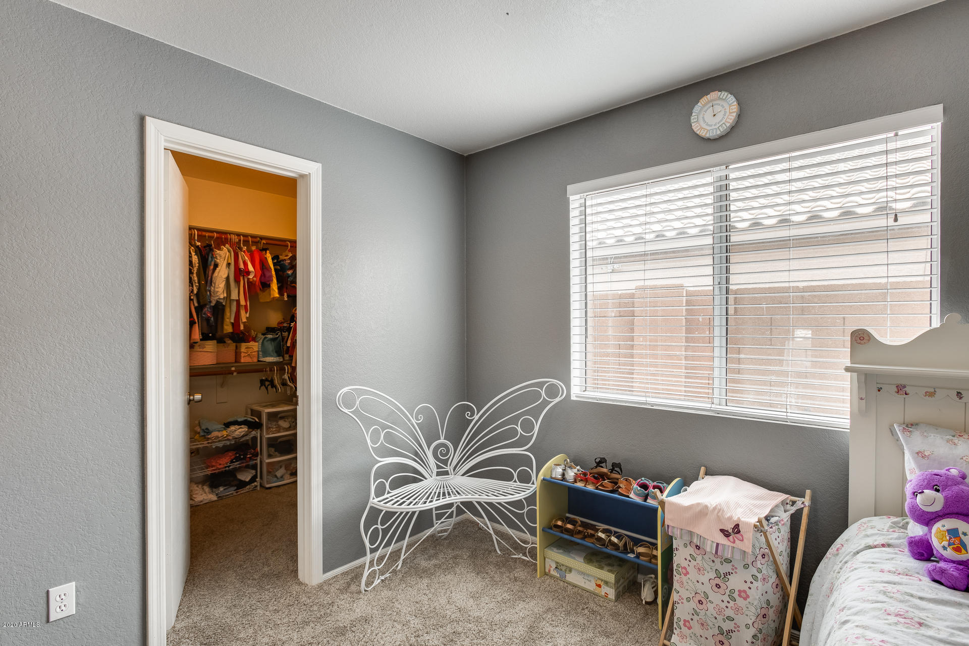8713 West Coronado Road Phoenix, AZ 85037 - Photo 18 of 27 a bedroom with a bed and a window