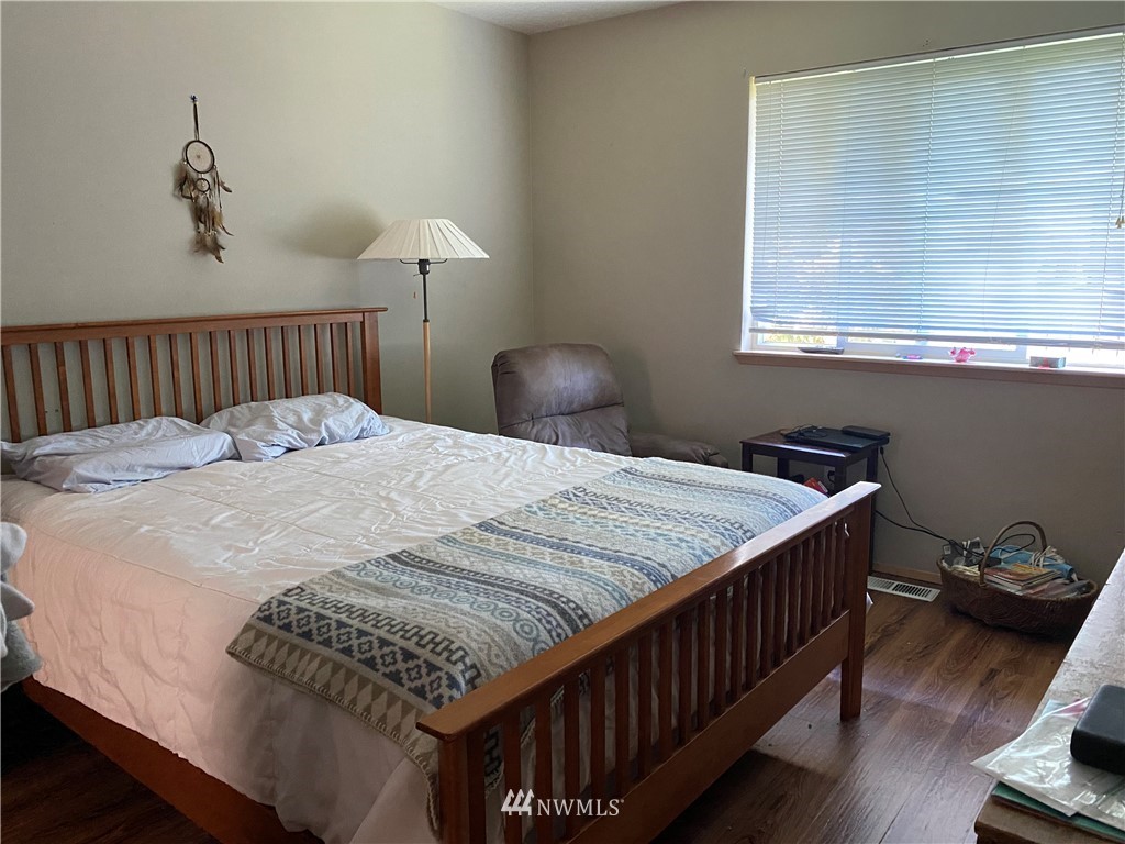 2105 Michigan Street Bellingham, WA 98229 - Photo 12 of 38 a bedroom with a bed and wooden floor