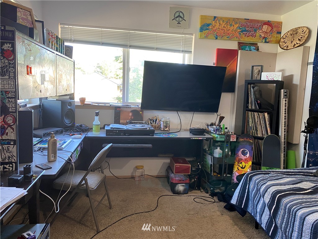 2105 Michigan Street Bellingham, WA 98229 - Photo 14 of 38 a living room with furniture a flat screen tv and a fireplace