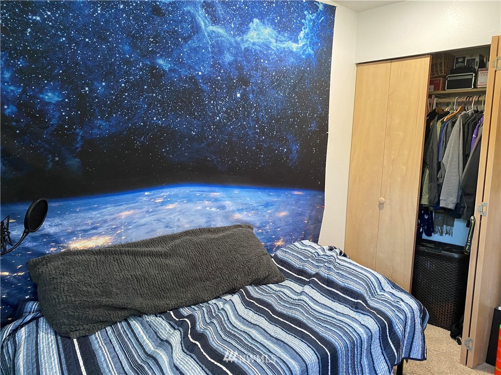 2105 Michigan Street Bellingham, WA 98229 - Photo 16 of 38 a bedroom with a bed and a walk in closet