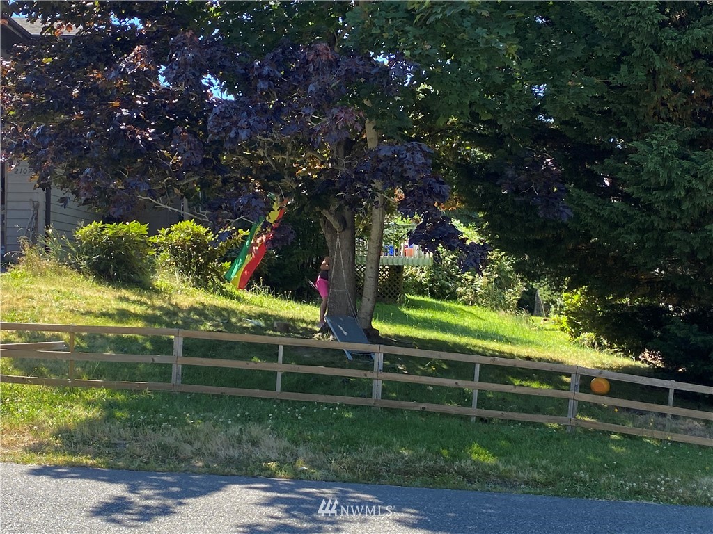 2105 Michigan Street Bellingham, WA 98229 - Photo 19 of 38 a view of backyard with wooden fence and a large tree