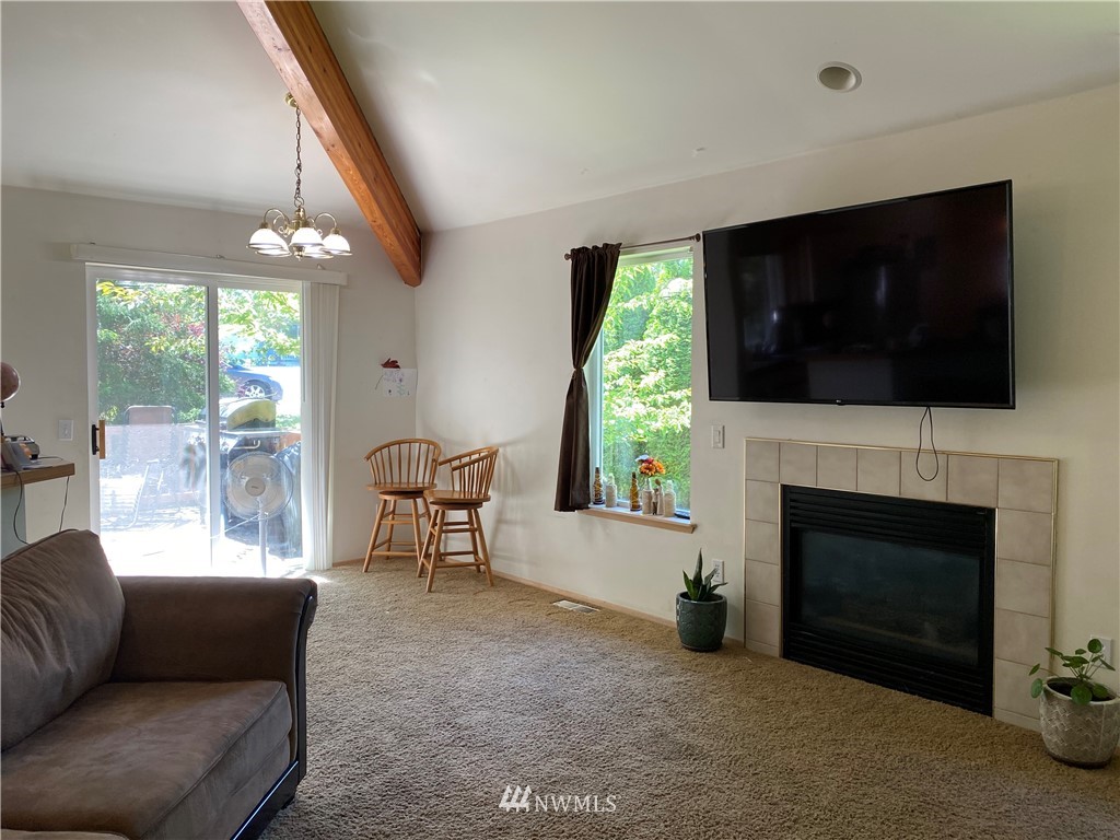 2105 Michigan Street Bellingham, WA 98229 - Photo 28 of 38 a living room with furniture a flat screen tv and a fireplace