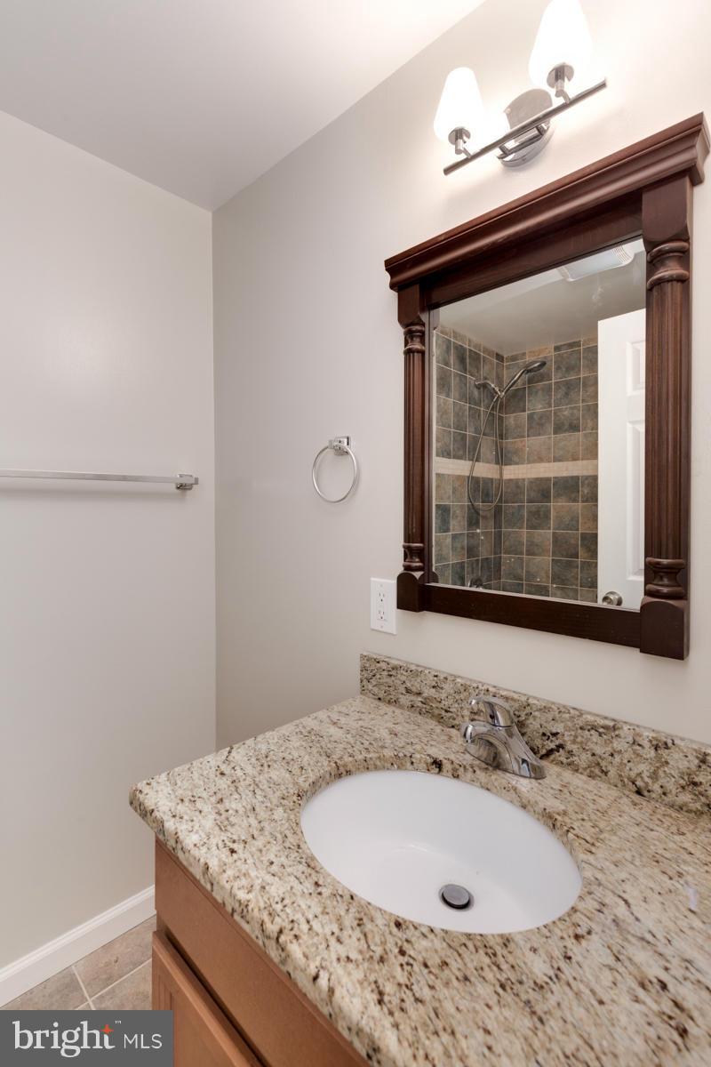 11052 Granby Court Reston, VA 20191 - Photo 12 of 28 a bathroom with a sink and a mirror