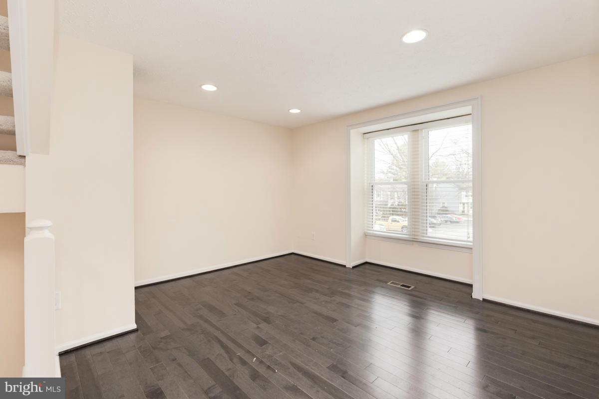 11052 Granby Court Reston, VA 20191 - Photo 8 of 28 an empty room with wooden floor and windows