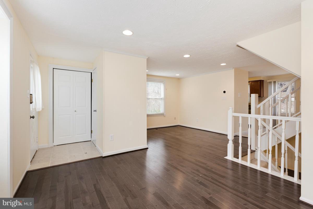 11052 Granby Court Reston, VA 20191 - Photo 9 of 28 an empty room with wooden floor and windows
