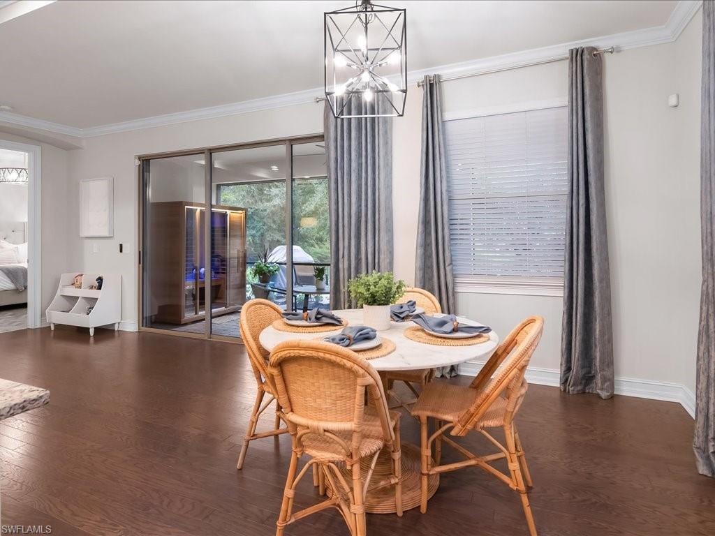 16242 Aberdeen Way Naples, FL 34110 - Photo 12 of 30 a view of a dining room with furniture wooden floor and chandelier