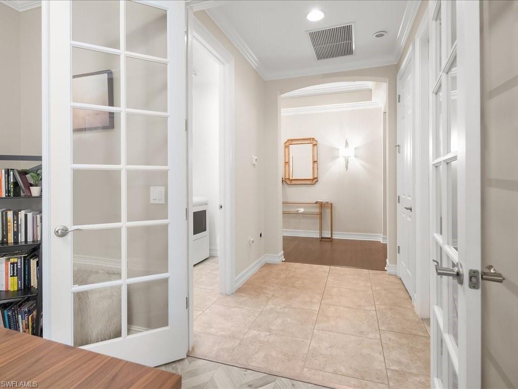 16242 Aberdeen Way Naples, FL 34110 - Photo 22 of 30 a view of a bedroom with cabinet and door