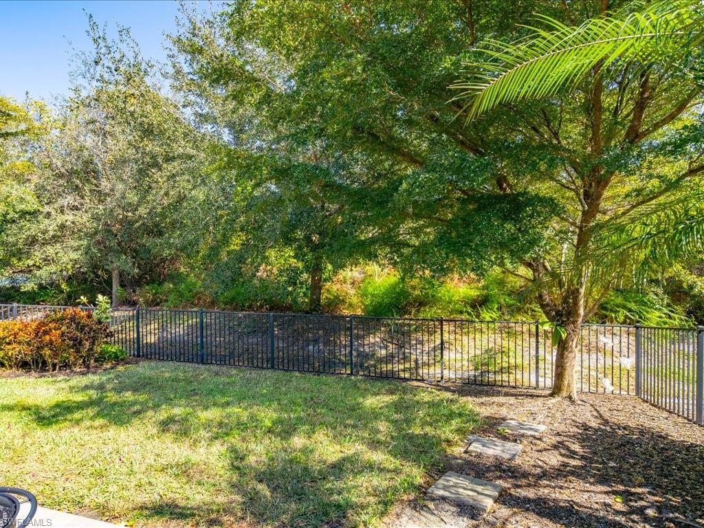 16242 Aberdeen Way Naples, FL 34110 - Photo 29 of 30 a view of a yard with a large tree