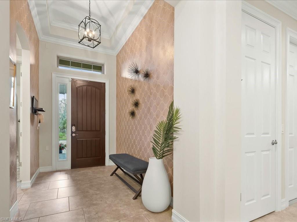 16242 Aberdeen Way Naples, FL 34110 - Photo 3 of 30 a view of entryway with chandelier and glass door