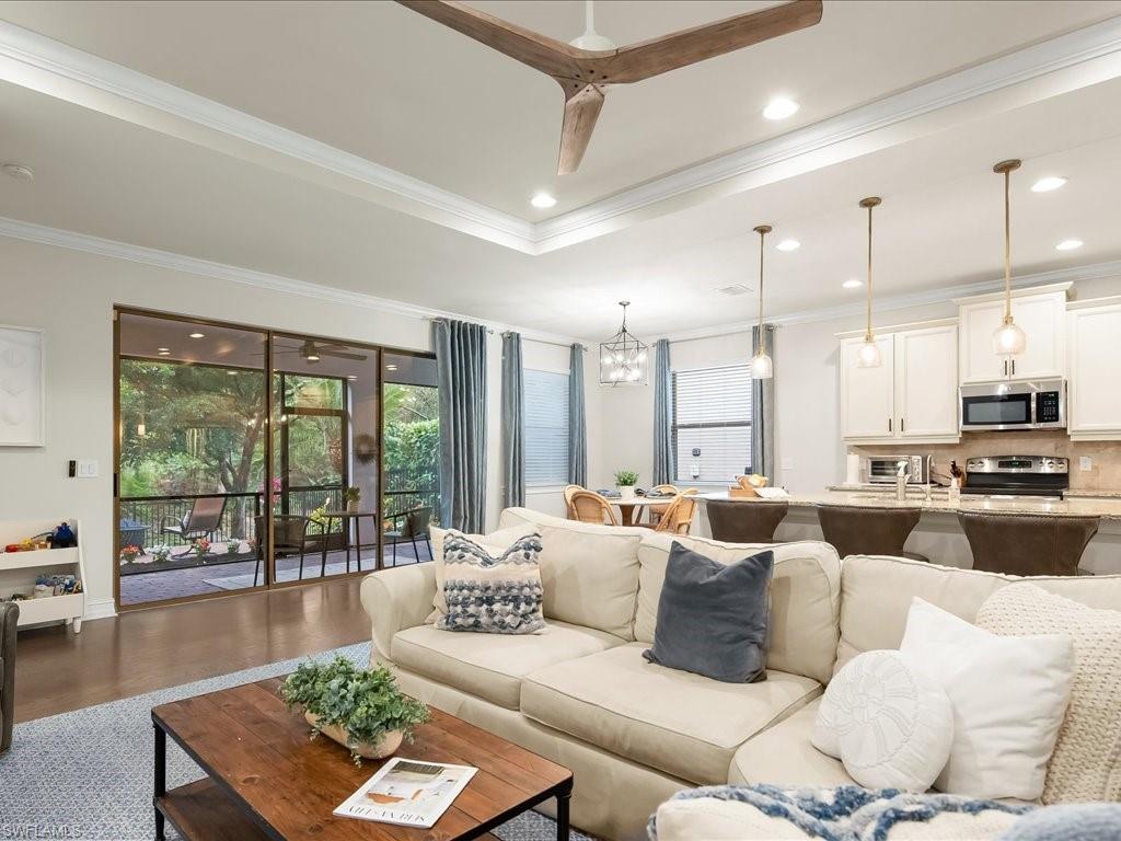 16242 Aberdeen Way Naples, FL 34110 - Photo 7 of 30 a living room with furniture wooden floor and a large window