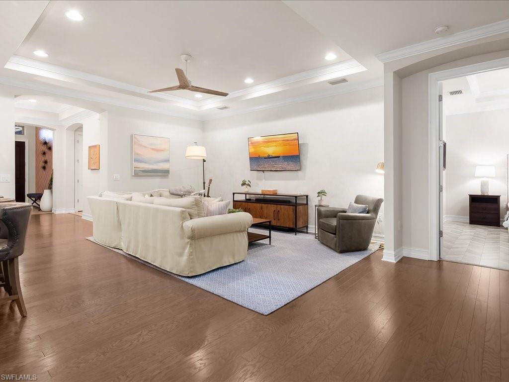 16242 Aberdeen Way Naples, FL 34110 - Photo 8 of 30 a living room with furniture and a flat screen tv