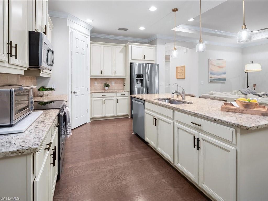 16242 Aberdeen Way Naples, FL 34110 - Photo 10 of 30 a kitchen with a sink stove and refrigerator