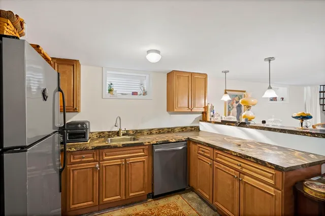a kitchen with stainless steel appliances granite countertop a sink stove and refrigerator