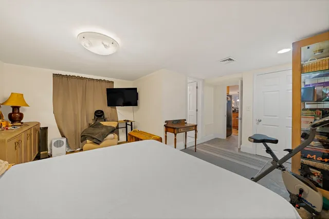 a bedroom with a bed and a flat screen tv