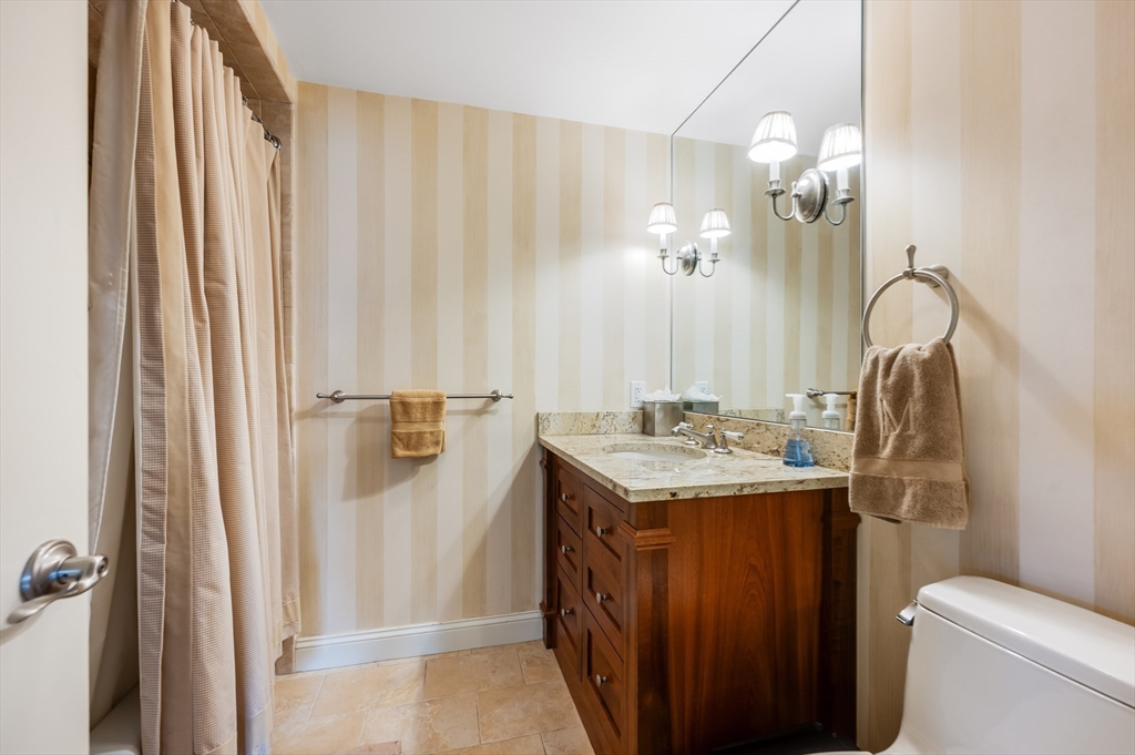 63 Atlantic Avenue, Unit 7E Boston, MA 02110 - Photo 20 of 37 a bathroom with a sink toilet and shower