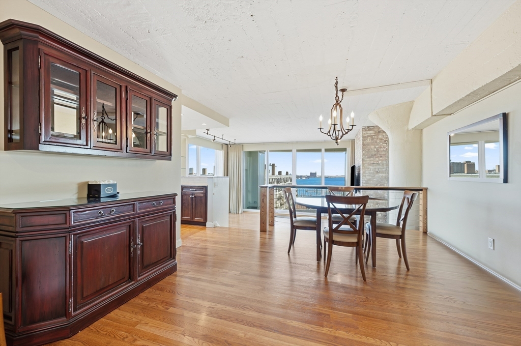 63 Atlantic Avenue, Unit 7E Boston, MA 02110 - Photo 8 of 37 a view of a dining room with furniture and wooden floor