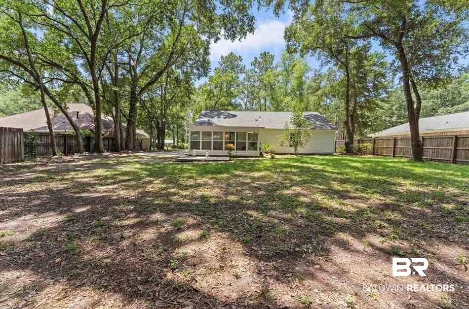10251 Windmill Road Fairhope, AL 36532 - Photo 44 of 44 Back of property featuring a sunroom and a fenced backyard