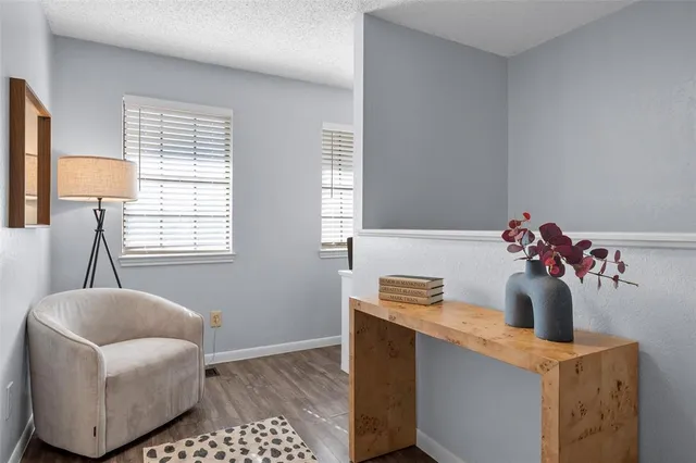 a hallway with a couch and chandelier