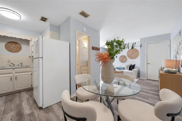 a dining room with furniture and wooden floor