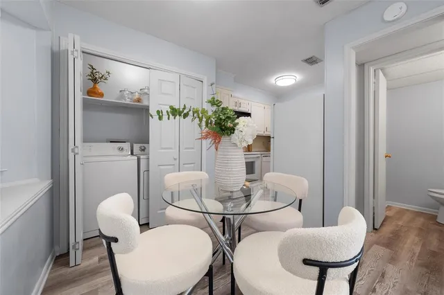 a dining room with furniture and wooden floor