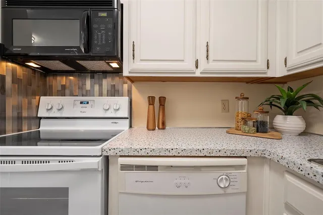 a kitchen with granite countertop cabinets and a stove