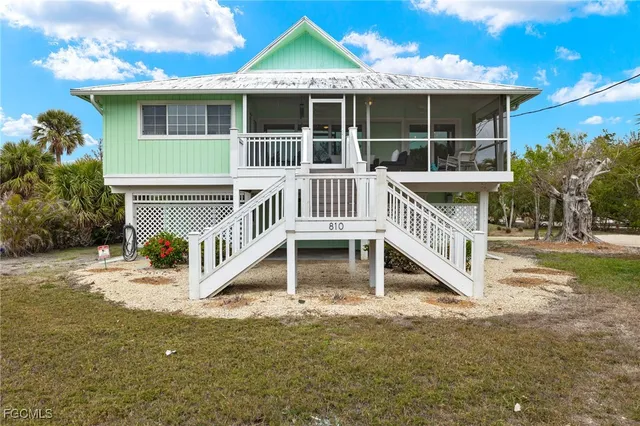 a view of house with a yard and balcony